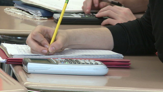 Junior high students writing in class