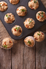 muffins with ham and cheese in baking dish. vertical top view
