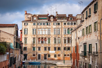 Fototapeta na wymiar City landscape of Venice. The street canal with old houses, boats