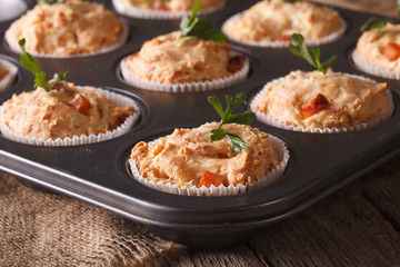 muffins with ham and cheese in baking dish close up. horizontal

