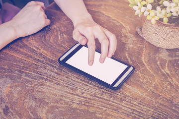 Close up of hands woman using phone in coffee shop