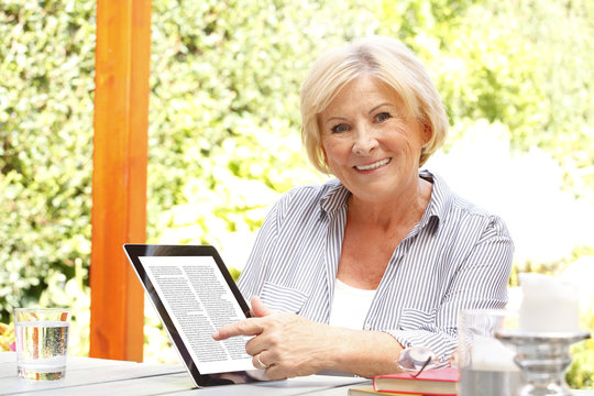 Senor woman with diigital tablet