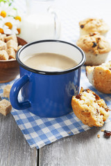 Mug coffee with milk and muffins