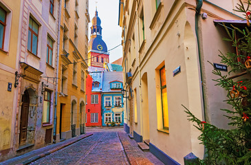 Narrow street leading to the St. Peter church in Old Riga