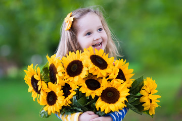 Little girl with sunflowers