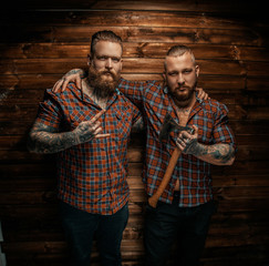 Obraz premium Two mans with beards and tattoo.