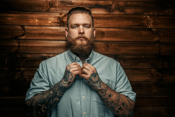 Brutal man with beard and tatoos.
