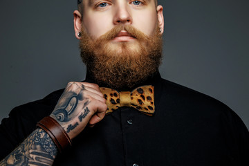 Man with beard in black t shirt.