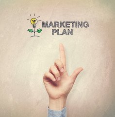 Hand pointing to Marketing Plan concept