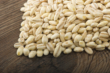 Spoon of Pearl barley close up on a table