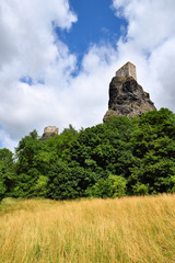 High volcanic cliff with castle towers rising high above the for