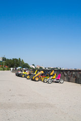 Naklejka premium Electric cars for hire on the promenade by the sea