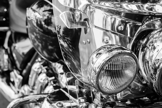 brilliant headlight motorcycle on a blurry black and white background