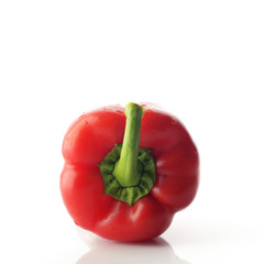 High Resolution Image Of Red Bell Pepper With Green Stem over White Background, Shot In Studio.