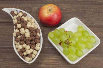 Healthy Diet breakfast of oatmeal, cereal and fruit. Foods full of energy for athletes. The concept of diet food. Preparing homemade breakfast. Vegetarian diet. Food on a wooden table.
