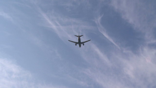 Plane coming in for a landing over the water 