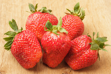 Red fresh strawberry fruits on wooden table.