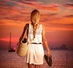 Blond braid tourist girl looking sunset with flip flop
