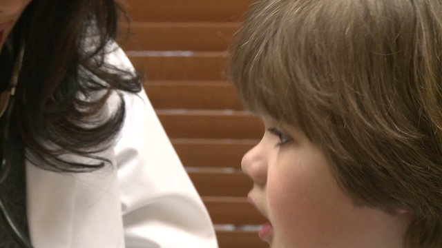 Female nurse checks child's breathing