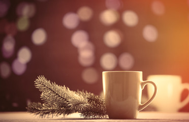 Cup of tea and pine branch with Christmas lights