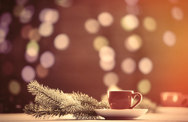 Obraz na płótnie Canvas Cup of tea and pine branch with Christmas lights