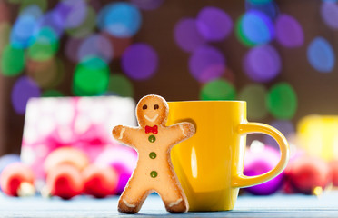 Obraz na płótnie Canvas Cup of tea and cookie with Christmas lights