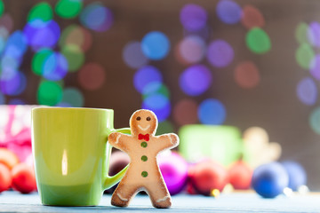 Obraz na płótnie Canvas Cup of tea and cookie with Christmas lights