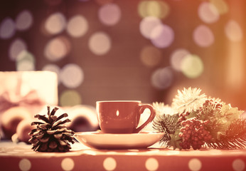 Cup of tea and branch with Christmas lights
