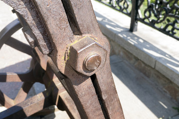 Aged rusty nut on the old mechanism. Close up view, outdoor.