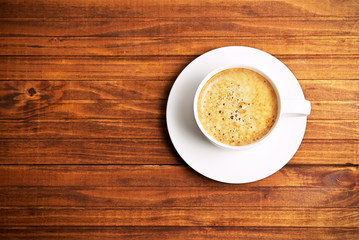 Cup of coffe on wooden background. Concept photo, top view