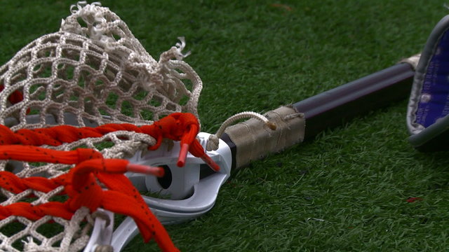Lacrosse equipment laying on the field