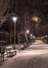 Krakow, Poland, alley in the Planty park seen in the night during snow.