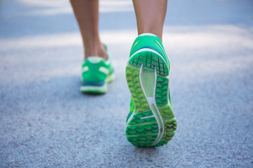 close up of female legs running on road