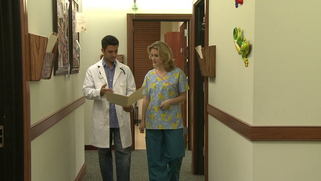 Doctor and nurse have hallway discussion