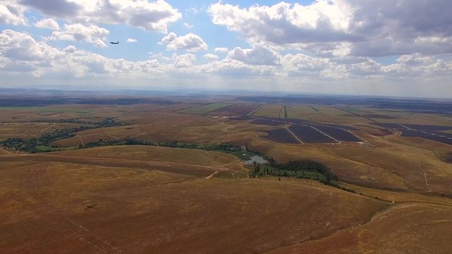 Passenger Plane Flying Over Rural Fields And Landing
