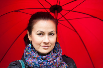 Woman under red umbrella