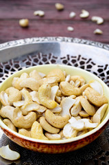 Assorted nuts in dishes on wooden table