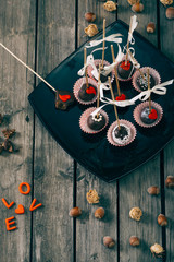 Cake-pop on wooden table.