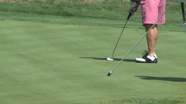 Golfers putting