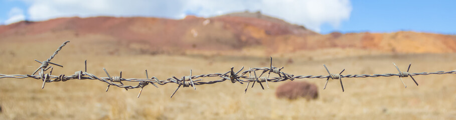 barb wire on a desert landscape