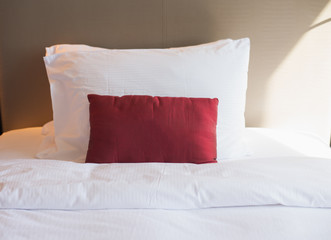 Bed and white  pillow in bedroom