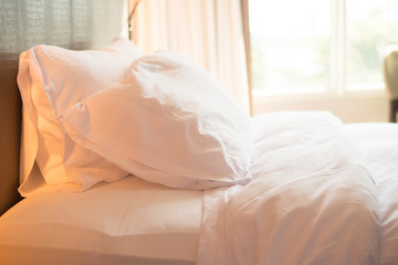 Bed and white  pillow in bedroom