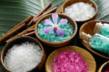 Fototapeta na wymiar colorful sea salt ,orchid in wooden bowl with orchid on banana leaf 