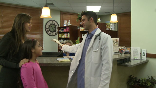Doctor consults with family after checkup