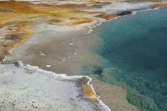 Thermal pool with deep blue water and orange runoff, Yellowstone