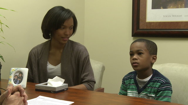 Young boy and mom talk with doctor