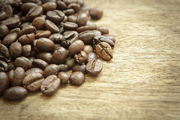 Coffee beans on wooden background.