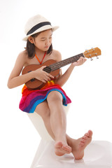 little girl in  dress playing the ukulele