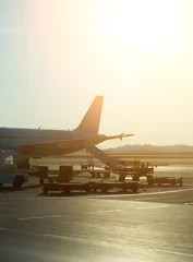 Photo sur Plexiglas Aéroport Passenger plane in the airport at sunrise. Aircraft maintenance.