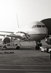 Passenger plane in the airport. Aircraft maintenance. Black and white photo.